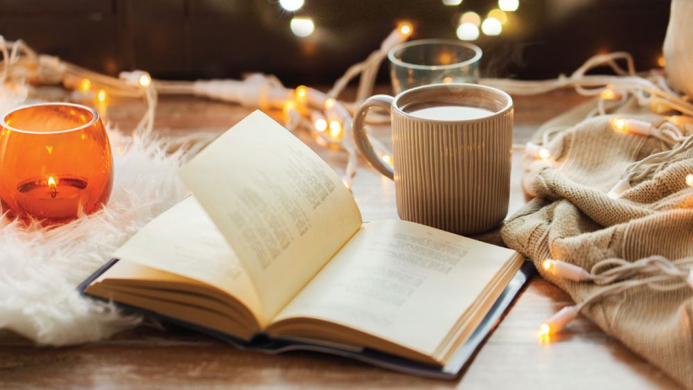 cozy home with book and candle