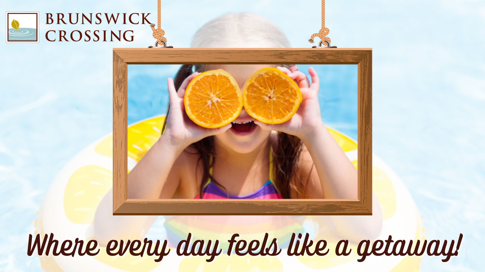 young girl swimming in pool float with oranges covering eyes in a picture frame with the Brunswick Crossing logo and campaign slogan 